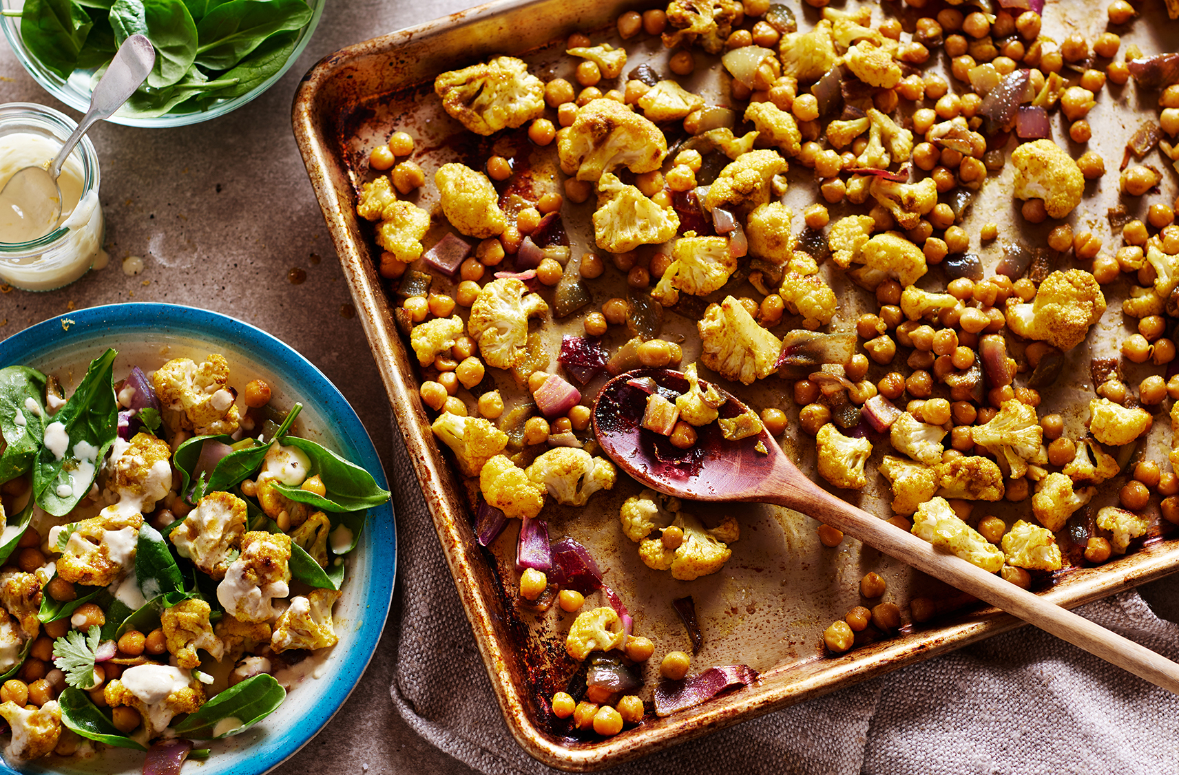 A pan of nicely roasted and spiced cauliflower, chick peas and red onions