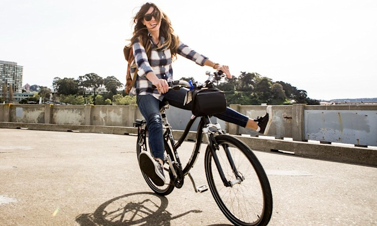 Happy woman riding bicycle on World Sight Day