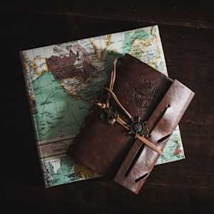 A map and travel journal on a black background