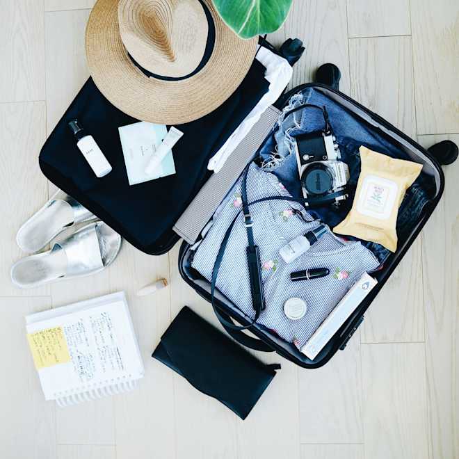 Flat lay of a packed vacation suitcase