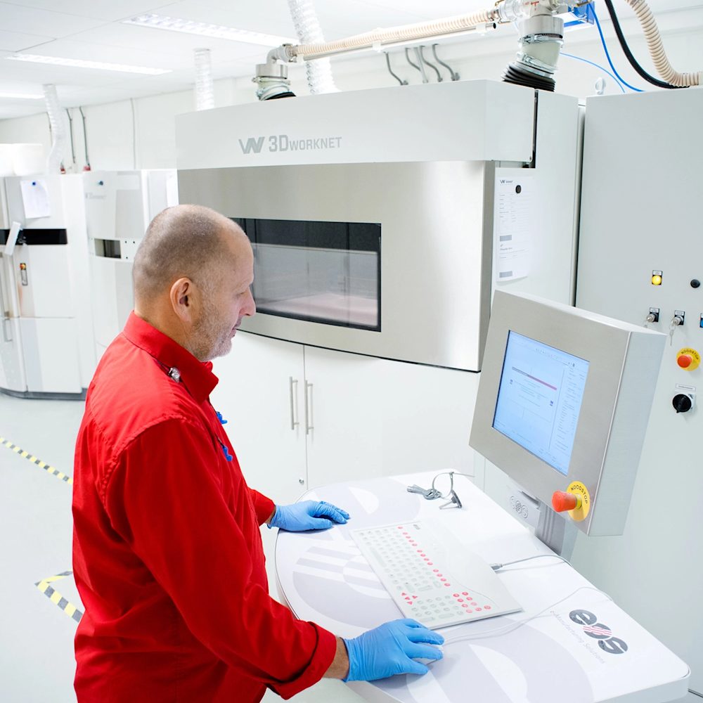 Man operating a 3D printing machine