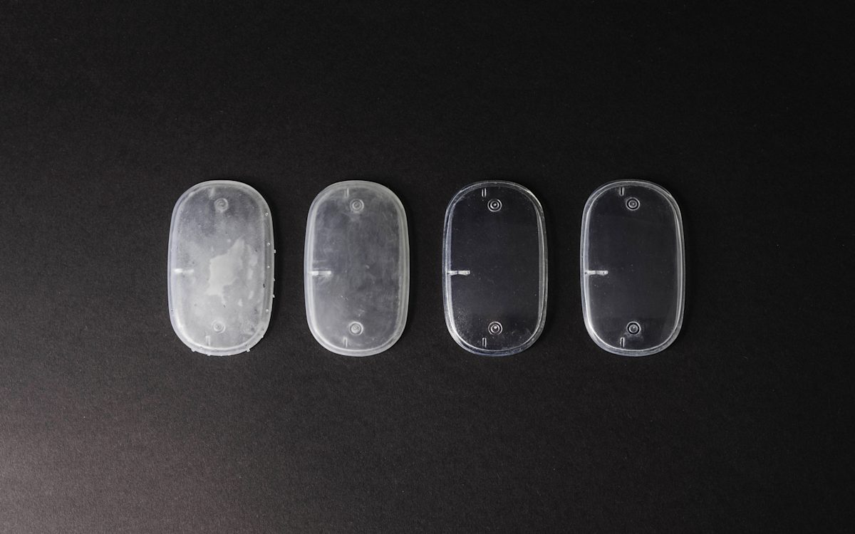 SLA part printed in clear resin, showing different post-processing stages.