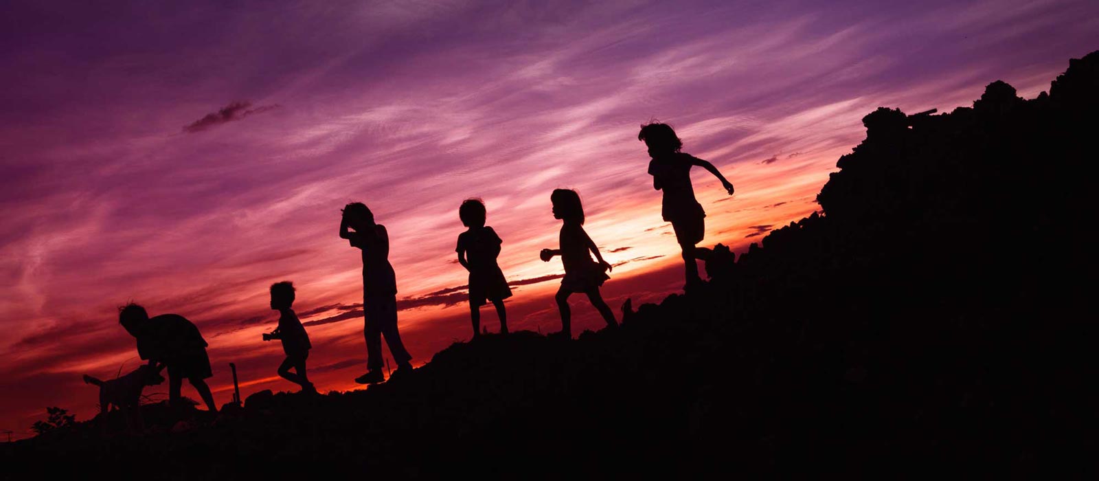 Group of children walking together at sunset
