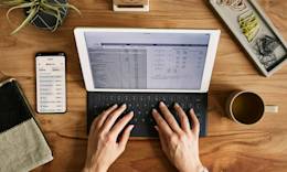 Person creating budget on a tablet.