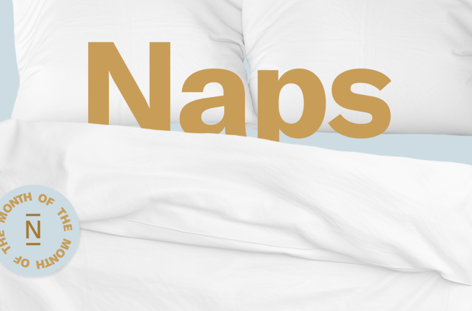 The word Naps tucked into a white sheet and resting on pillows.