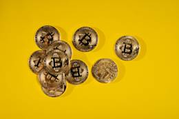 Bitcoin coins on a yellow background.