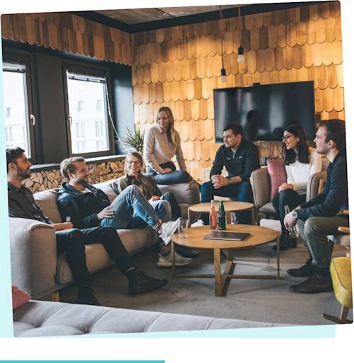 Interns sitting around on chairs and sofas in a cozy looking N26 meeting room.