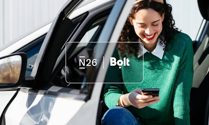 a girl holding a smartphone N26 x Bolt.