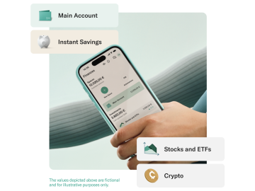 Hand holding a mobile with the N26 app open and showing the account balance and Stocks and ETFs balance.