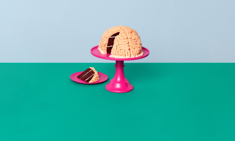 Money worries are weighing on our minds image with a brain cake on a pink stand.