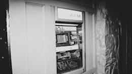 Black and white ATM on the street.