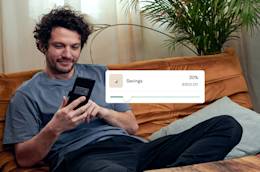 Man sitting on a couch and using the new income sorter feature.