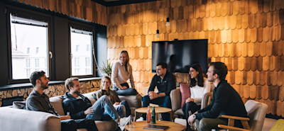N26 inters sitting on couches and chairs in a cozy looking meeting room.