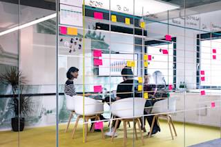 A view of a meeting room through its glass walls, at the N26 Mitte location.