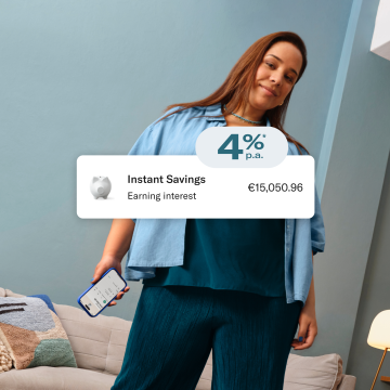 Image showing 4% interest rate for savings accounts and a woman dressed in blue holding a cell phone in the background.