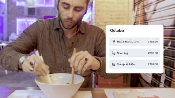 Man eats a bowl of ramen showing N26 monthly wrap up.