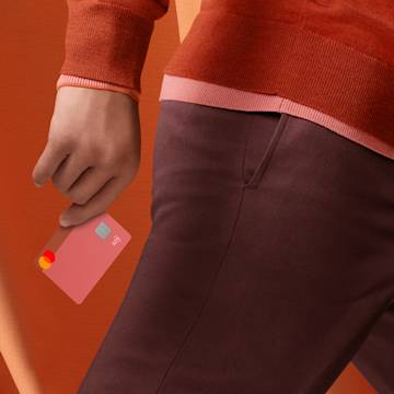 A person holding a Rhubarb colored You card in their hand.