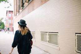 Woman with hat walking.