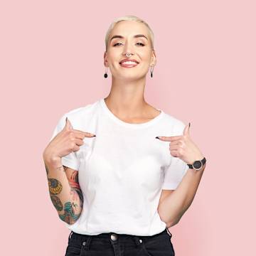 A girl with short blonde hair wearing a white t-shirt.
