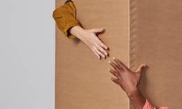 Two hands reaching to grab each other.