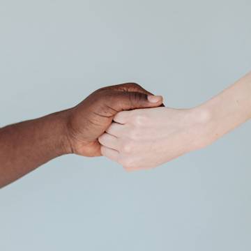 Two hands clasping onto each other.
