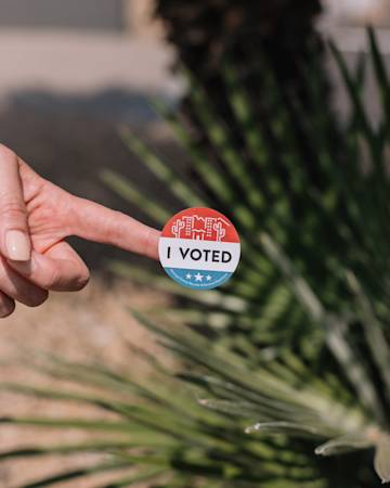 Finger with U.S. voting sticker.