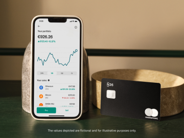 Black n26 Metal card next to an iPhone with the N26 open and showing the crypto interface.