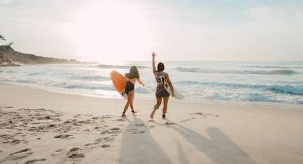 Two surfers about to go to the water.