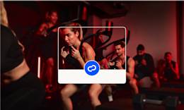 A woman is working out in a fitness class with other people.