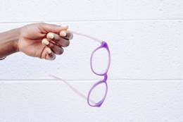 Hand holding glasses.