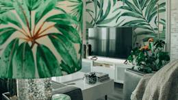 Living room with plant wallpaper and lamp.