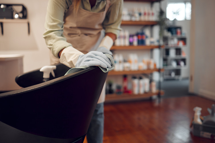 Woman cleaning hairdresser salon