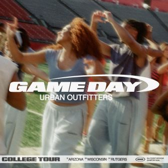 Game Day Urban Outfitters logo over blurred image of cheering sports fans with raised arms at a college event