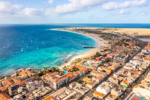 Pier and boats on turquoise water in city of Santa Maria, Sal, Cape Verde