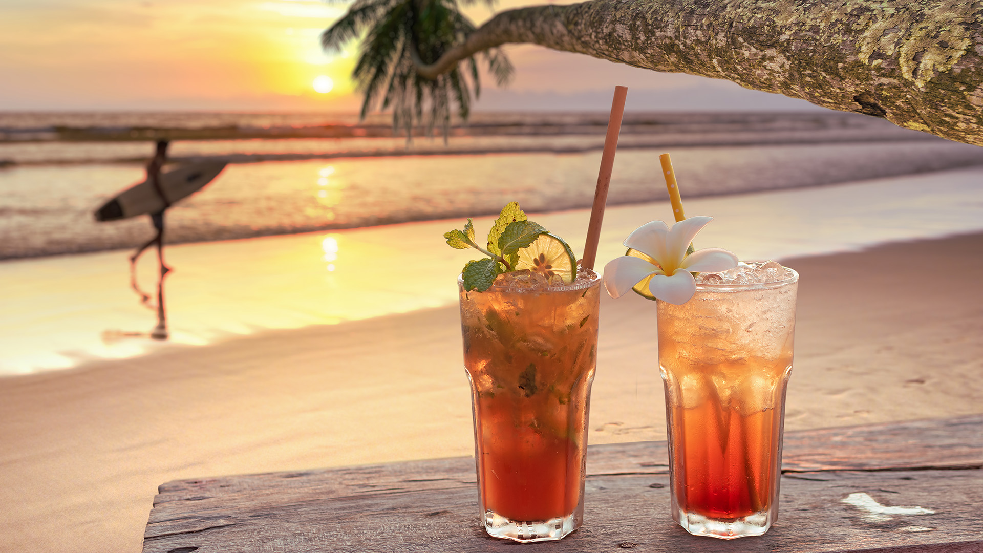 Drinks with blur beach and sunset in background
