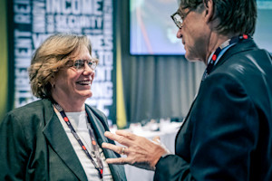 Woman smiling and talking with a man.