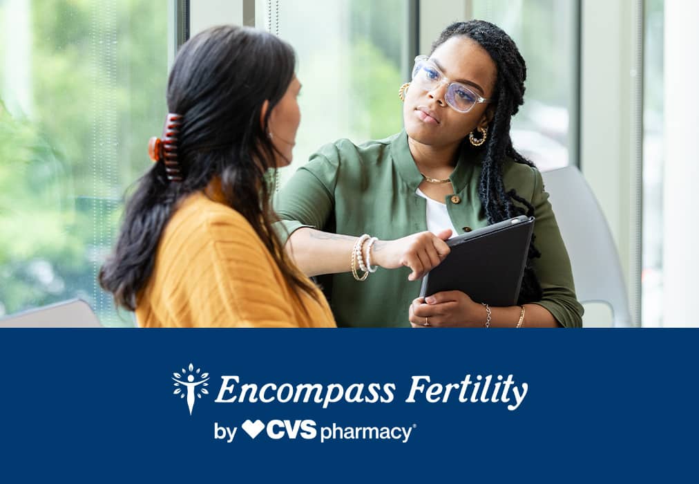 Encompass Fertility by CVS Pharmacy® logo; two women in conversation