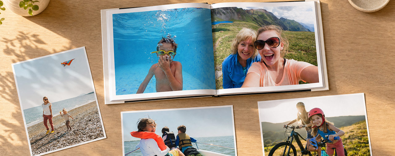 Up to 85% off select products. CVS photo books and cards of families at the beach, on hikes and biking along a scenic route — all lying flat on a brown countertop.