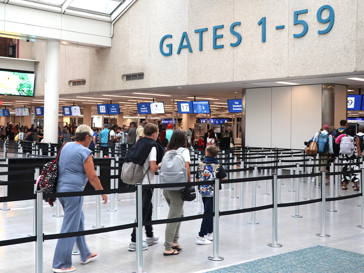 Photo of people walking towards Gates 1-59 security checkpoint.