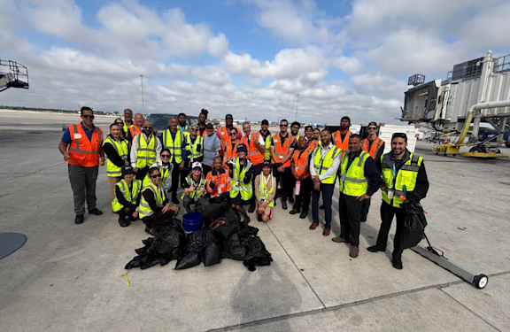 Group photo of MCO Safety Team working together with JetBlue Airlines at Terminal C cleaning up Foreign Object Debris.
