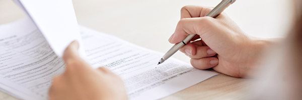 A person signing a contract.