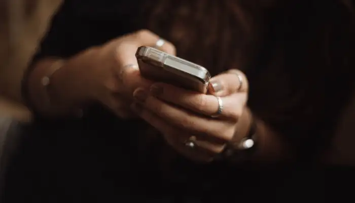 woman holding and using a mobile phone