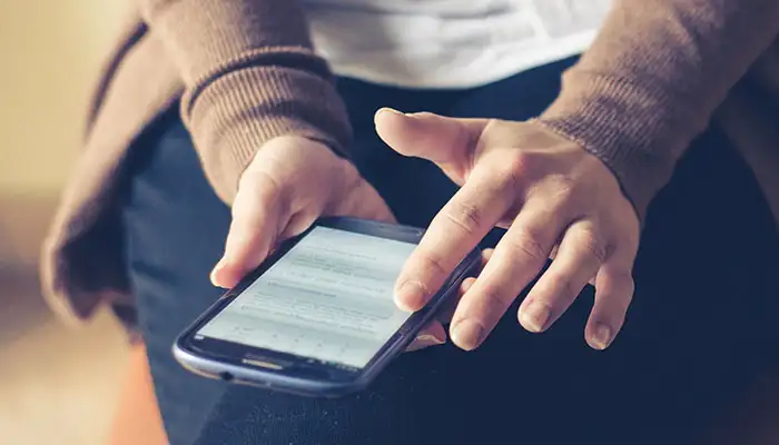 a person sat working on their mobile phone
