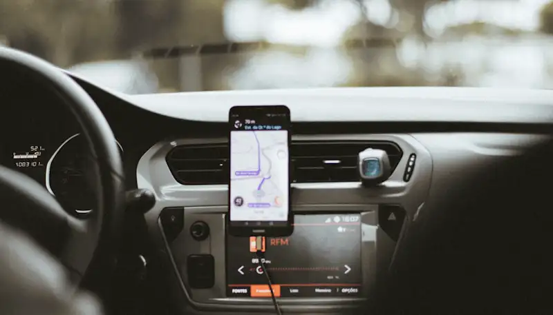 mobile phone being used as a sat nav on a car dashboard