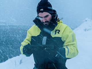Person holding the Blueye Rugged controller in a snow storm