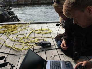 Andreas driving the drone with NRK's News Anchor,  watching closely to make a Live underwater interview.