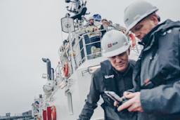 A team of people inspecting a vessel