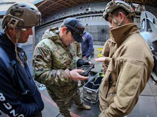 U.S. Navy Divers operating a Blueye ROV in the ballast tank of the ex-USS Fort McHenry