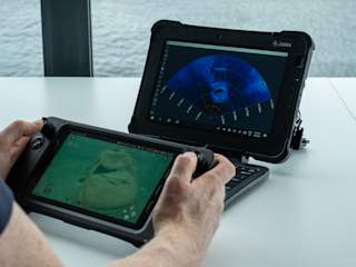 Operator using rugged controller and tablet watching Oculus sonar - horizontal