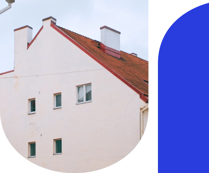 Side of a large house with a red roof tiles